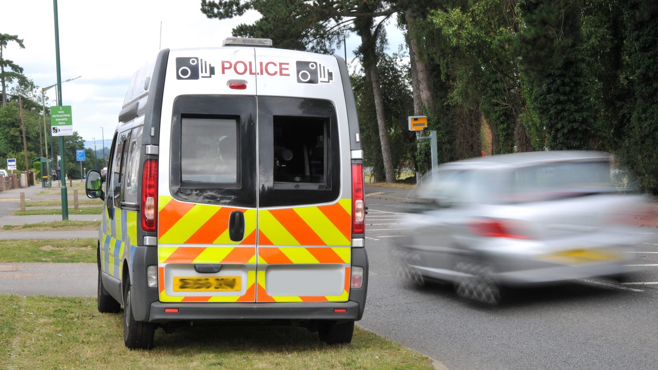 Mobile speed camera van in action with gatso speed camera in the background